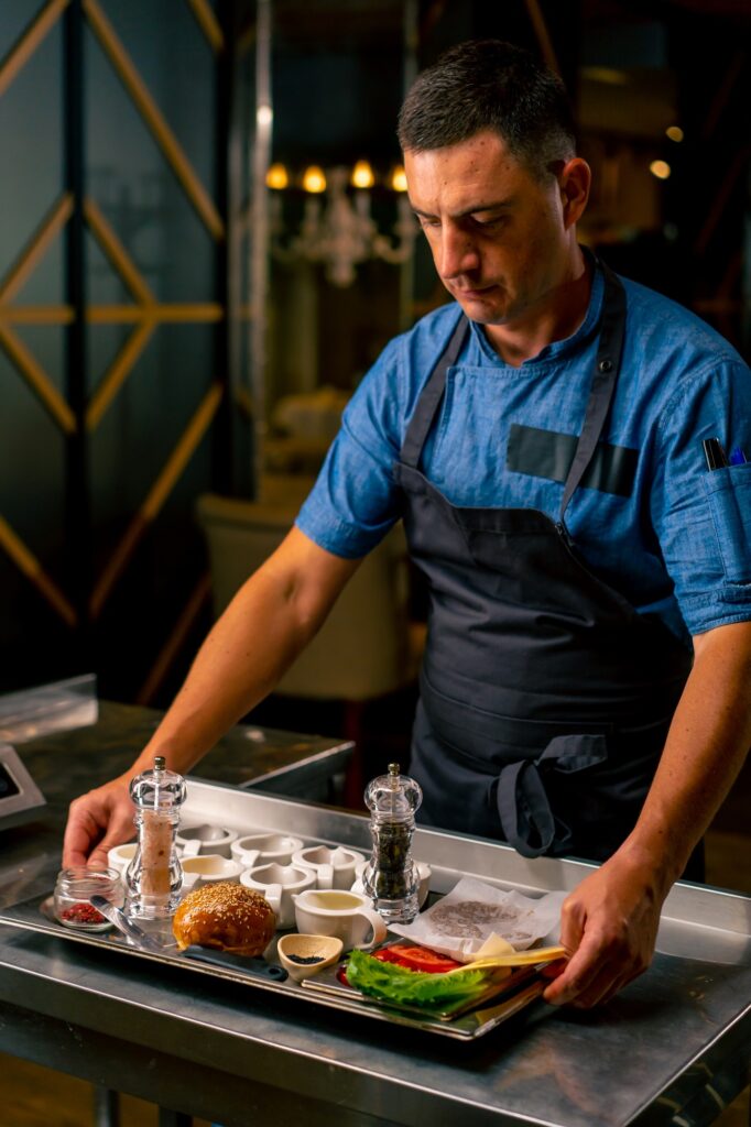 portrait of a chef in uniform standing in the professional kitchen of an Italian restaurant