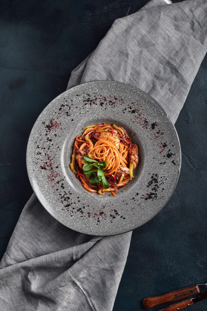 Spaghetti with vegetables tomato sauce and meat. Traditional italian food. Food photo. Dish from the