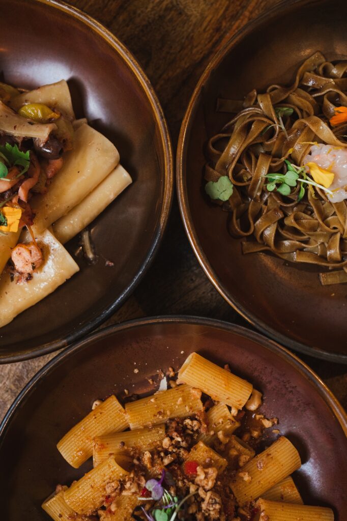 Top view of different tasty italian pasta plates at an italian restaurant